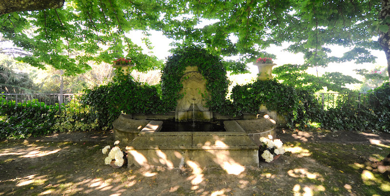 beautiful vine-covered fountain where acqua panna comes from in Mugello, Tuscany