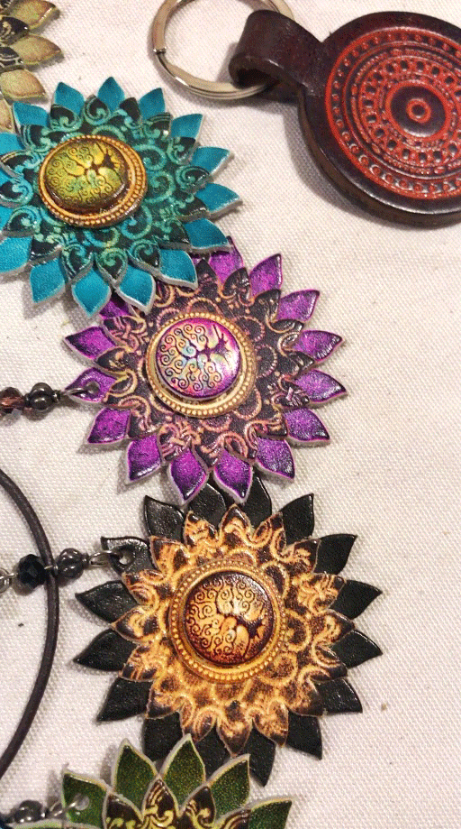 colorful handmade leather keychains with ornate magical designs