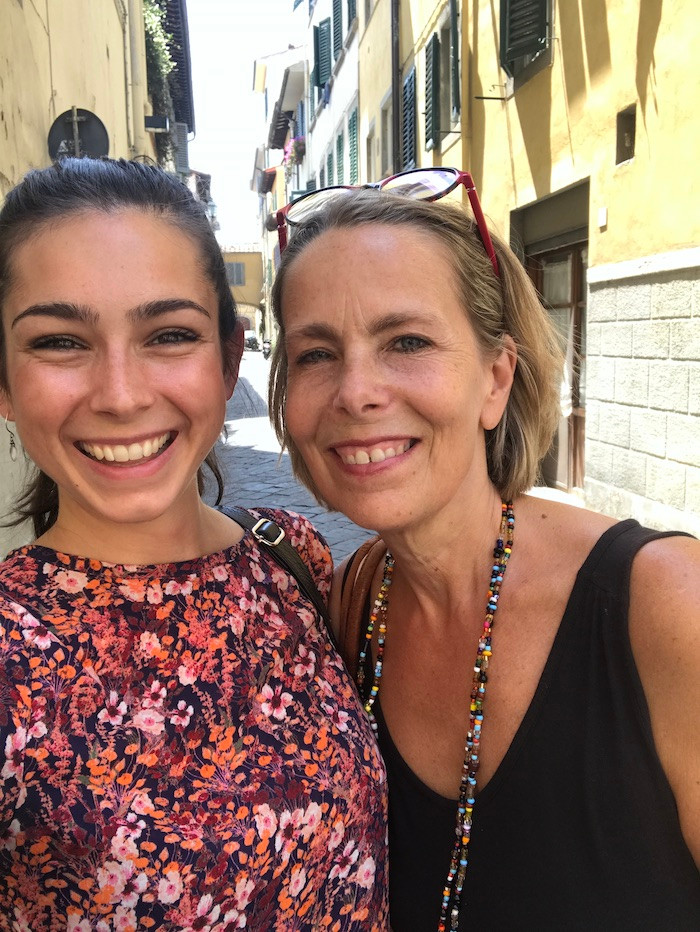 two ladies on a sunny day in an empty street in Florence smiling after an Artisan Walking Tour