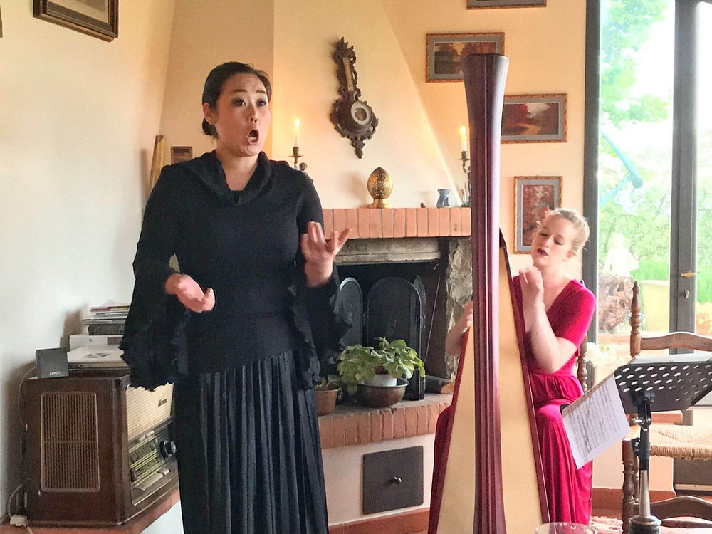 Opera singer with harpist in Tuscan living room