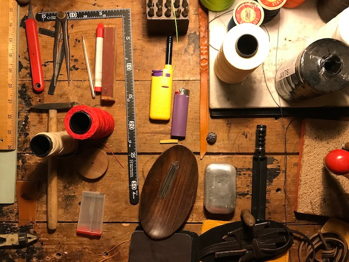 wooden table with artisan tools laid out