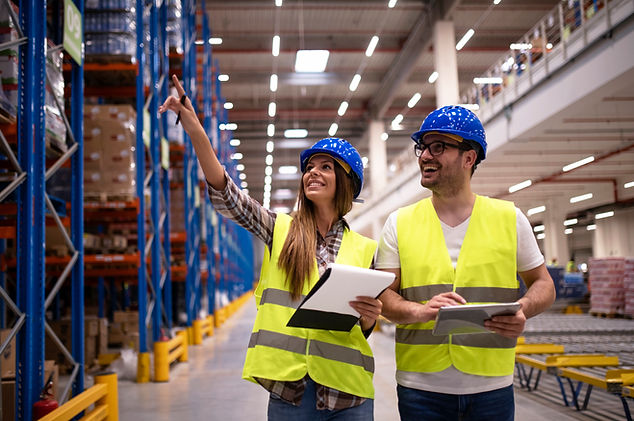 warehouse-workers-protective-uniform-walking-through-large-distribution-center-organizing-