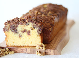 Walnut Coffeecake Loaf, sliced on a wooden board