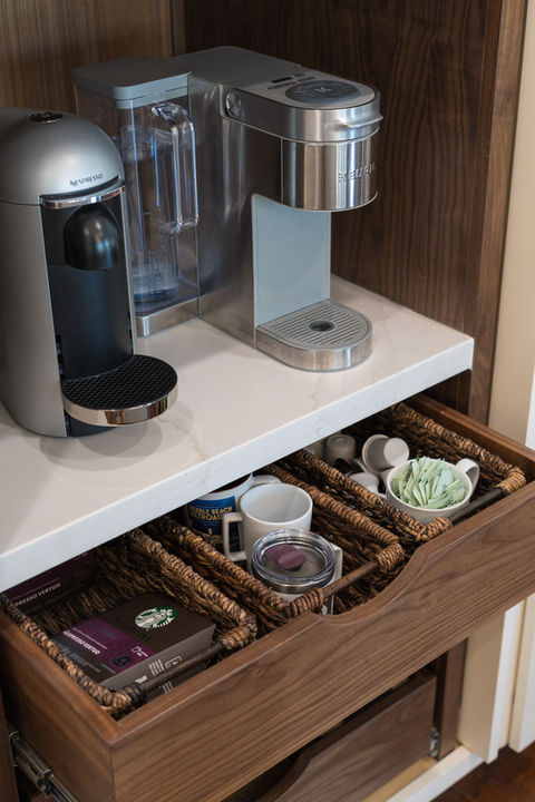 Nespresso, Custom Walnut Coffee Bar, MSI Calacatta Elysio 2cm Polished Quartz, waterfall island, Full height quartz backsplash, coffee bar, Top Knobs Honey Bronze Ascendrda, Artesso Brizo Kitchen Faucet and Potfiller, RH, Marisol Seagrass track arm counter stool Natural Seagrass, Rejuvenation, Conical 24" Pendant, Swiss Coffee kitchen cabinets with 2" shaker full overlay