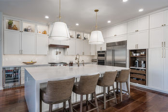 MSI Calacatta Elysio 2cm Polished Quartz, waterfall island, Full height quartz backsplash, coffee bar, Top Knobs Honey Bronze Ascendrda, Artesso Brizo Kitchen Faucet and Potfiller, RH, Marisol Seagrass track arm counter stool Natural Seagrass, Rejuvenation, Conical 24" Pendant, Swiss Coffee kitchen cabinets with 2" shaker full overlay, Low Voltage under cabinet lighting, espresso, Custom Walnut Coffee Bar, MSI Calacatta Elysio 2cm Polished Quartz, waterfall island, Full height quartz backsplash, coffee bar, Top Knobs Honey Bronze Ascendrda, Artesso Brizo Kitchen Faucet and Potfiller, RH, Marisol Seagrass track arm counter stool Natural Seagrass, Rejuvenation, Conical 24" Pendant, Swiss Coffee kitchen cabinets with 2" shaker full overlay, Sub Zero Refrigerator 48", Kitchen Aid Beverage Fridge