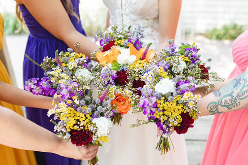 bride and bridesmaids holding bouquets together