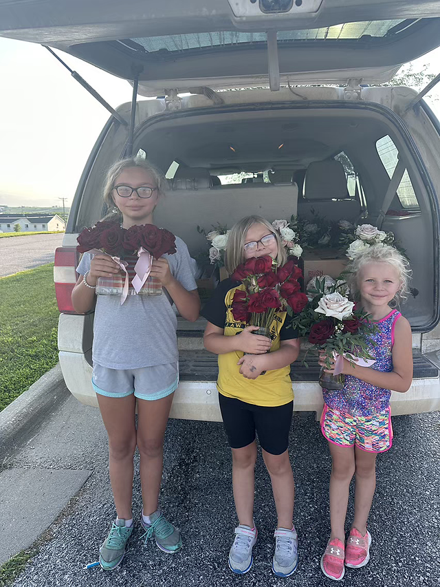 little girls with wedding flowers to donate to nursing home