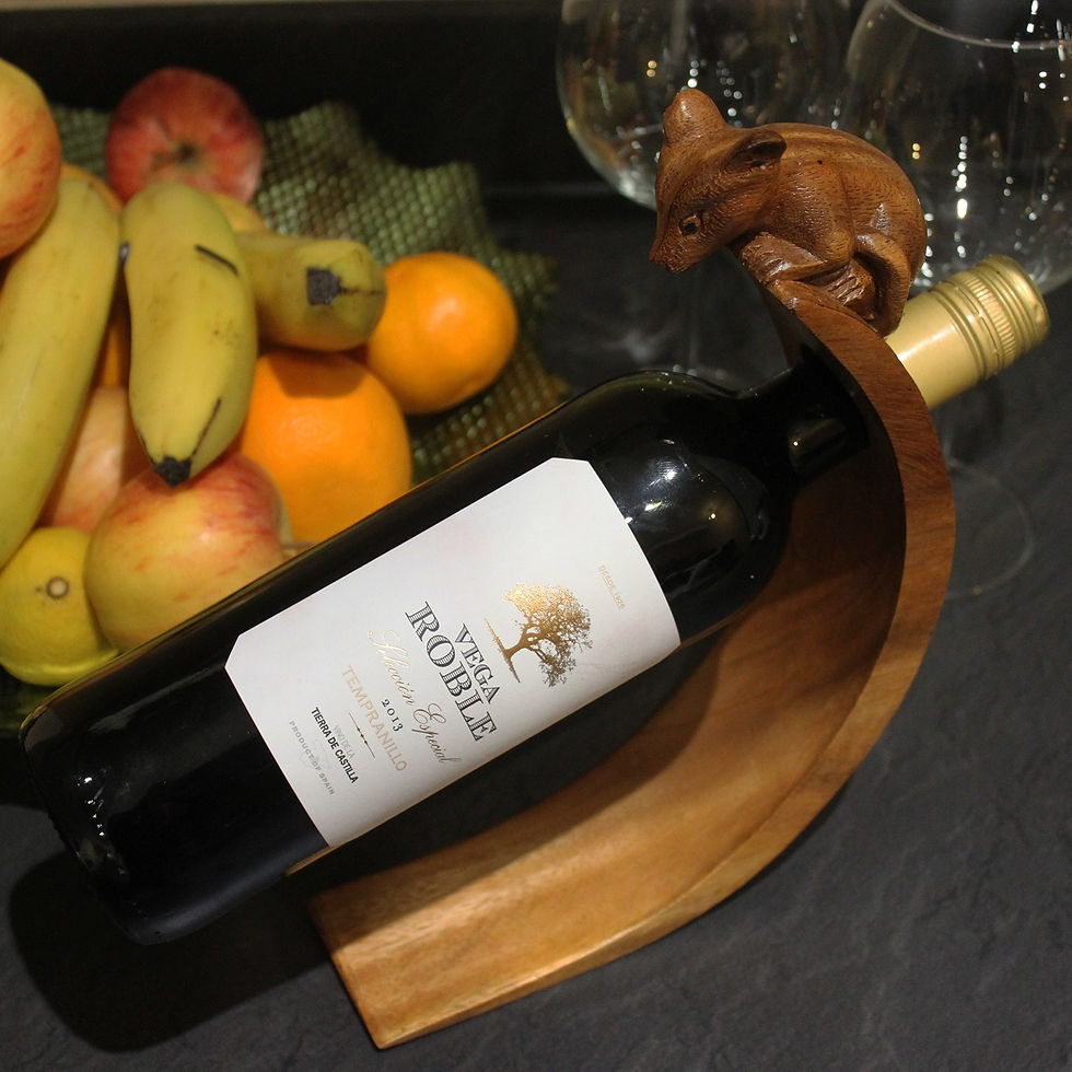 Thumbnail: Wine bottle in wooden holder with fruit