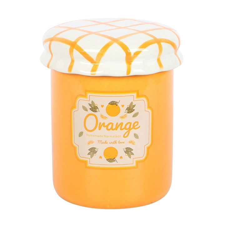 Orange scented candle in ceramic jar