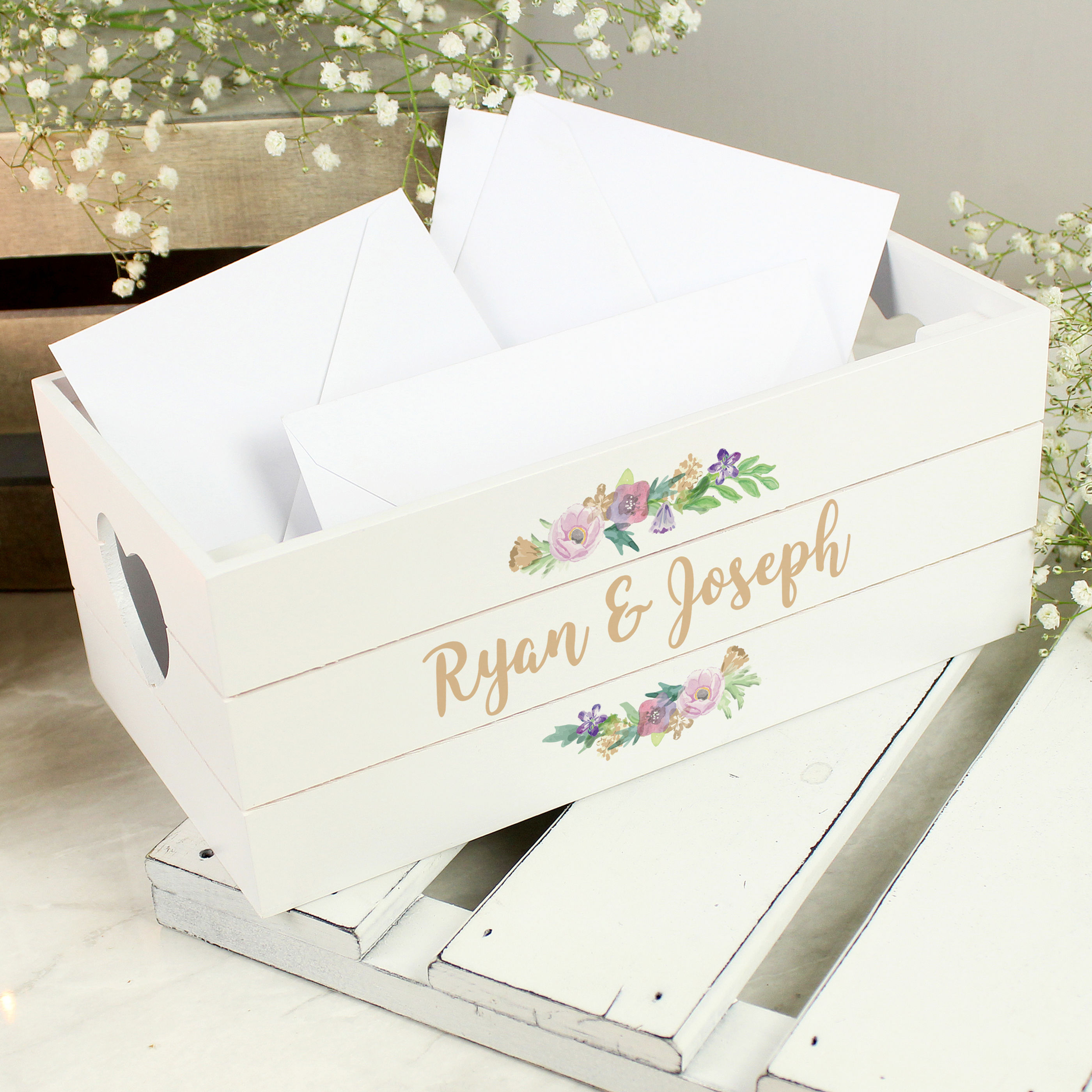 White wooden crate with Rylan & Joseph's names, floral design