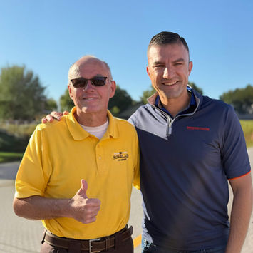 Les McFarland standing with representative Rudy Yakym.