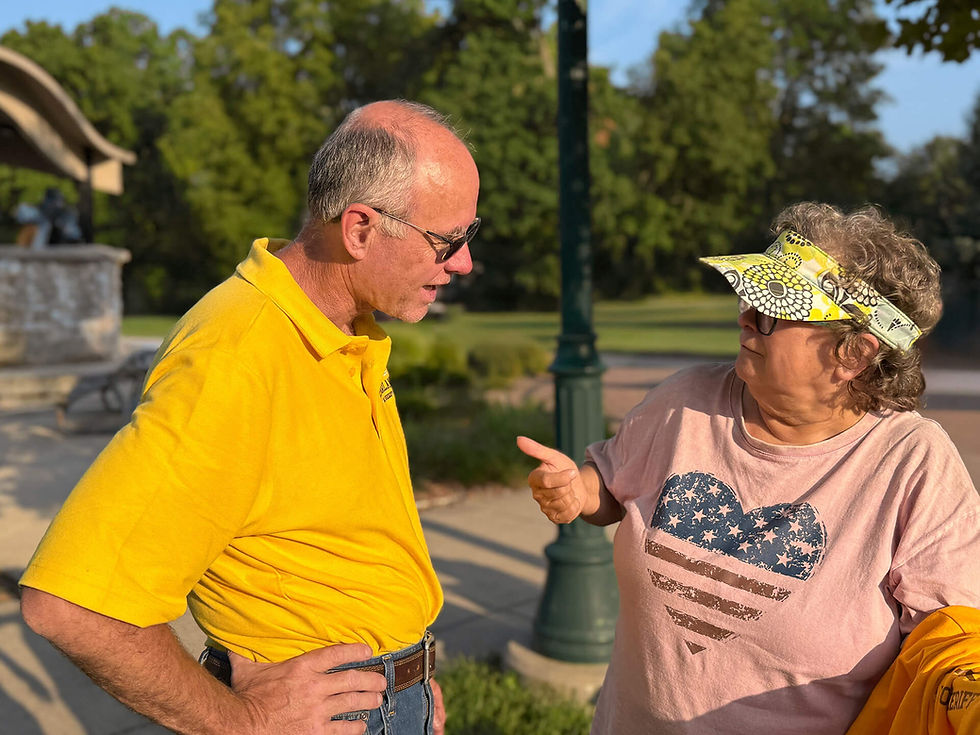 Les McFarland speaking with a local woman