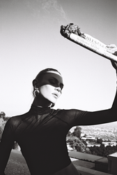 Fashion editorial photography by YIM STUDIOS featuring model posing beside red Ferrari sports car