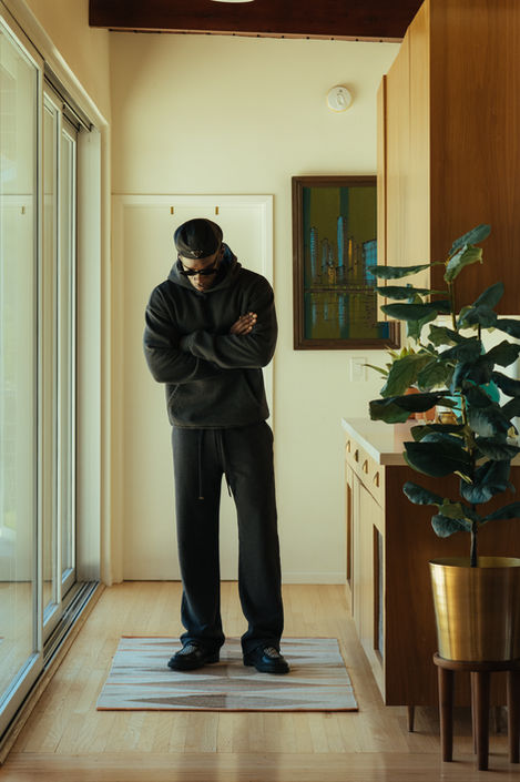 Streetwear portrait featuring model standing in hallway with natural light