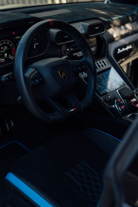 Lamborghini interior detail showing steering wheel and dashboard