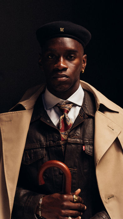 Cinematic menswear portrait with layered tailoring and dramatic lighting