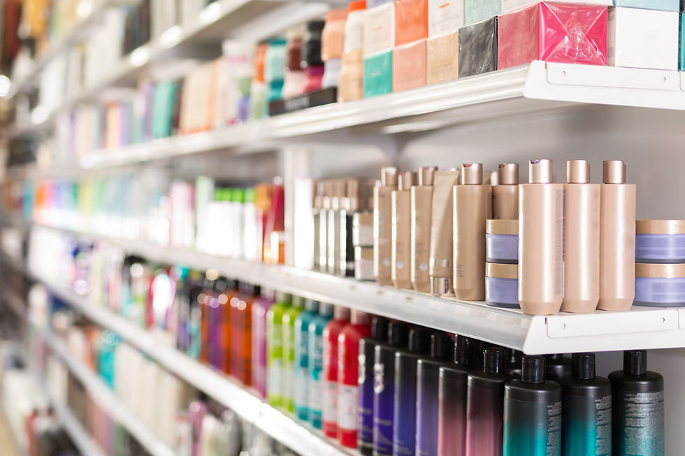 Bottles and boxes of different hair care products on store shelves in supermarket.jpg