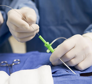 Surgeon Inserting Tube Into Patient During Surgery.jpg