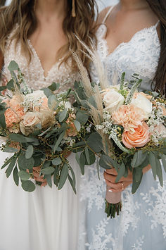 Two brides in wedding dresses holding their bouquets close up romantic photo for wedding b