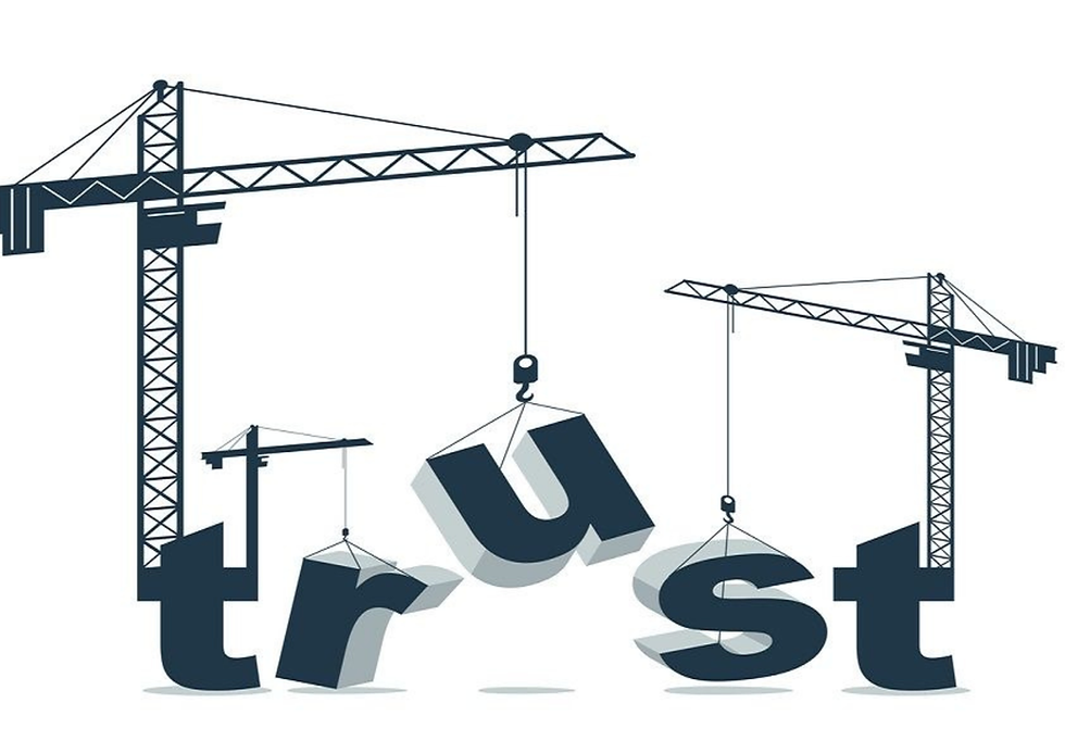 Two construction cranes lift the letters of trust against a white background, symbolizing building trust.
