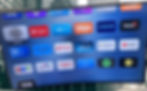 V home page showing various apps on a television screen