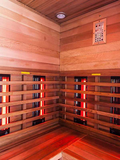 infrared sauna made of wood with glowing red light