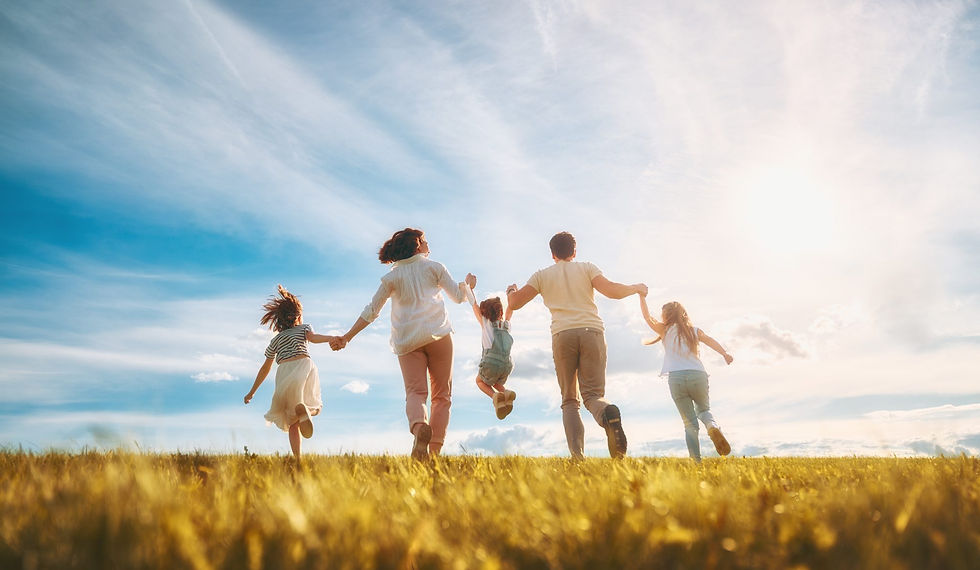 Happy family of five in a field. Chiropractic business