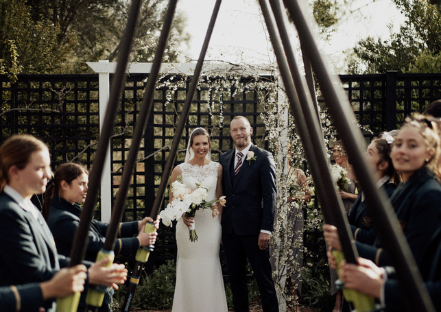 Bridge & Groom under oar salute aisle at Al Ru Farm