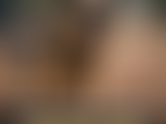 Dog showing aggressive behavior on a leash at a public dog park, with other dogs in the background.