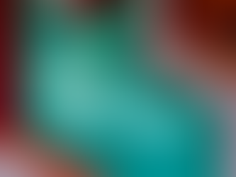 Neon sign reads "this must be the place" on a colorful geometric wall with teal, red, and orange patterns. Bright and inviting mood.