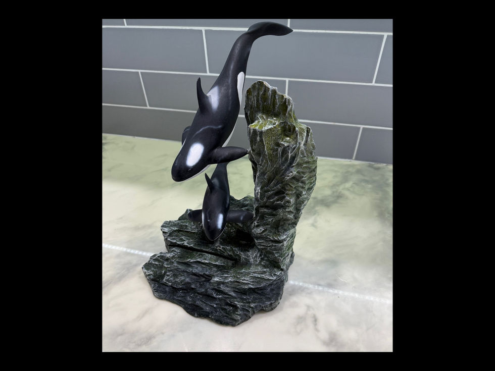 Wooden humpback whale mother and calf sculpture viewed from the side