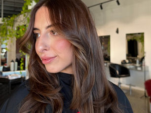 Client with fresh, glossy coloured hair after a salon colour appointment