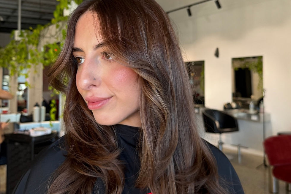 Client with fresh, glossy coloured hair after a salon colour appointment