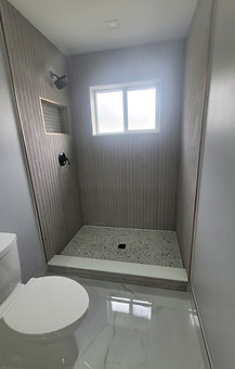 Modern bathroom with gray tiles and minimalist design – renovation in Miami Lakes