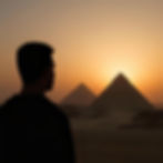 Man looking at the pyramids of Giza in the background