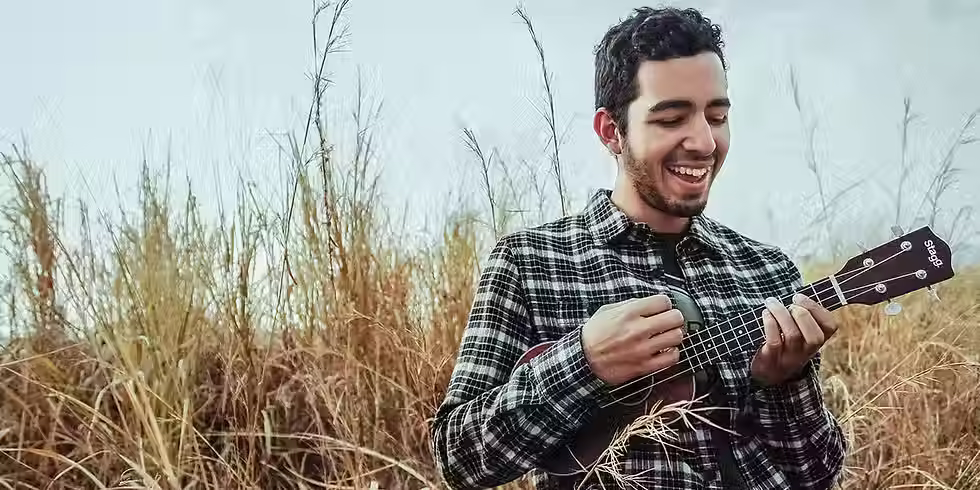 Man playing an instrument in a field