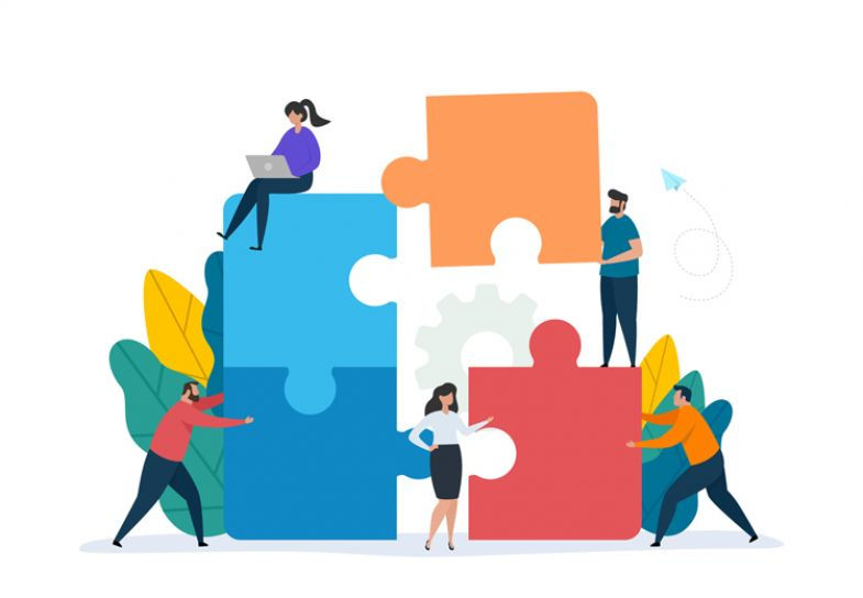 Group of diverse individuals collaboratively pushing puzzle pieces together, symbolizing teamwork and stakeholder engagement in project management