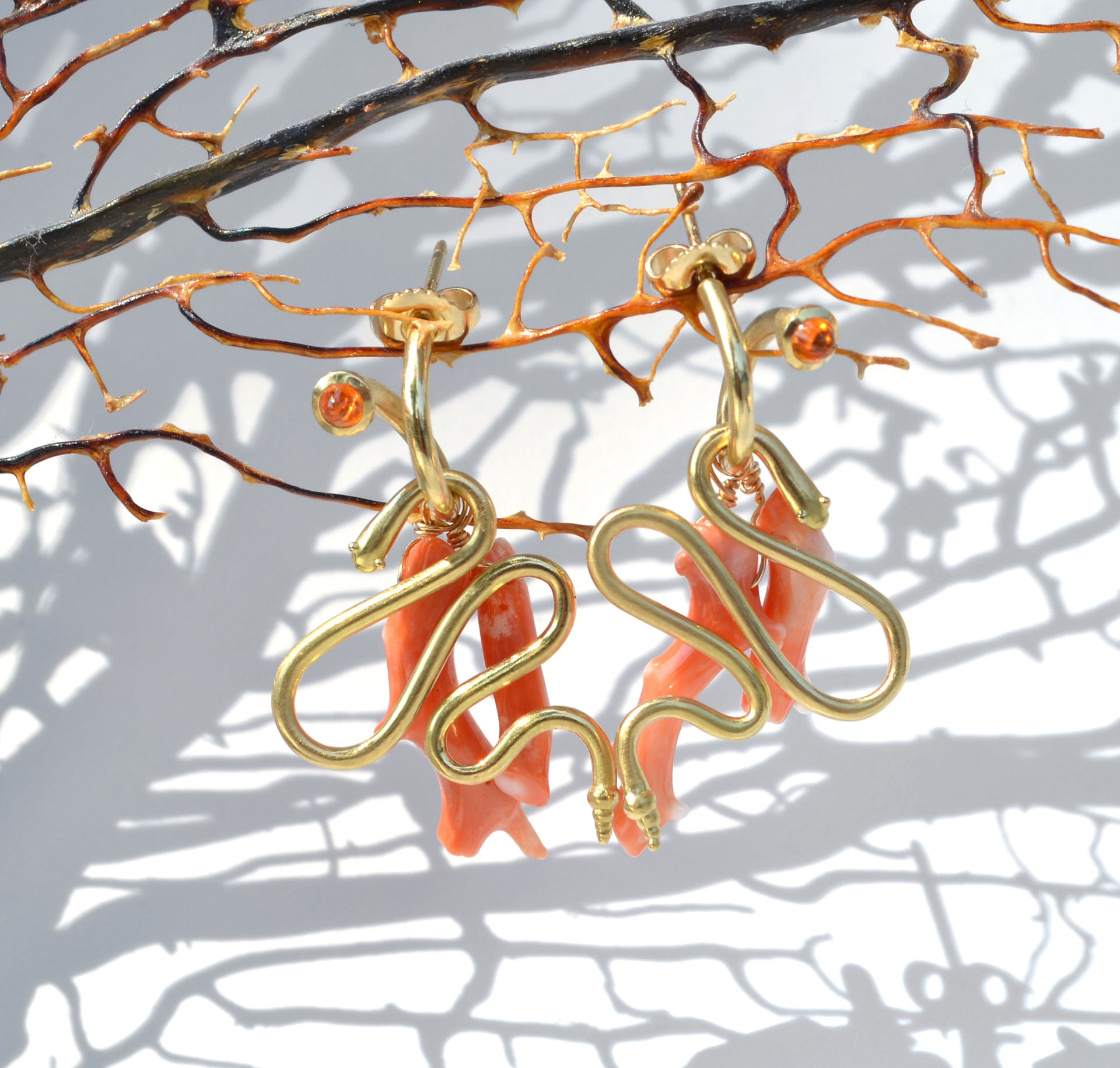 Orange garnet 18k yellow gold peek-a-boo hoop earrings with snake and coral branch charms