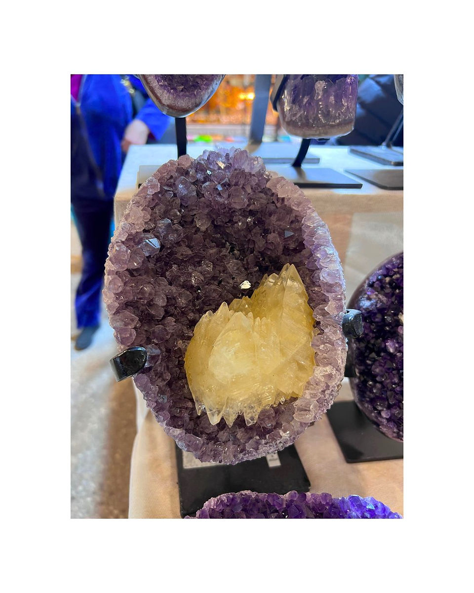 oval shaped amethyst geode with a large white quartz crystal inside