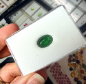 oval green tourmaline cabochon in a white box