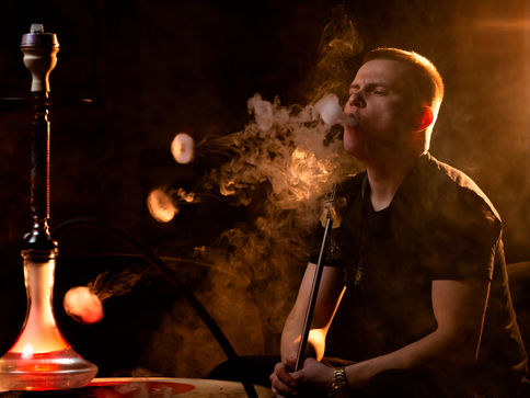 young-man-vaping-from-hookah-bar.jpg