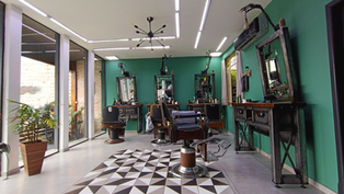 Espaço de atendimento da barbearia saint germain, cadeiras vintage confortáveis, espaço amplo e decoração contemporânea assinada