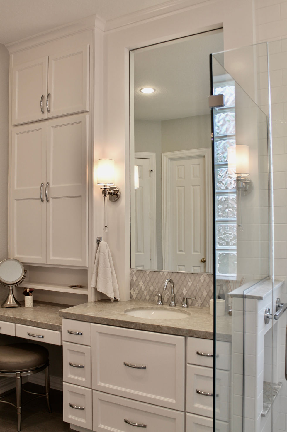 Freestanding Tub, Storage, White Cabinets, Hamper in Vanity, Mosaic Wall Tile, Polished Nickel Fixtures, Quartzite Countertops, Natural Stone Countertops, Large Format Floor Tile, Curbless Shower, Grab Bars, Hidden Shower Niche, Large Custom Mirrors, Sconces, Vanity, Make Up area, Storage, Drawers under Sink, Shower Body Sprayers