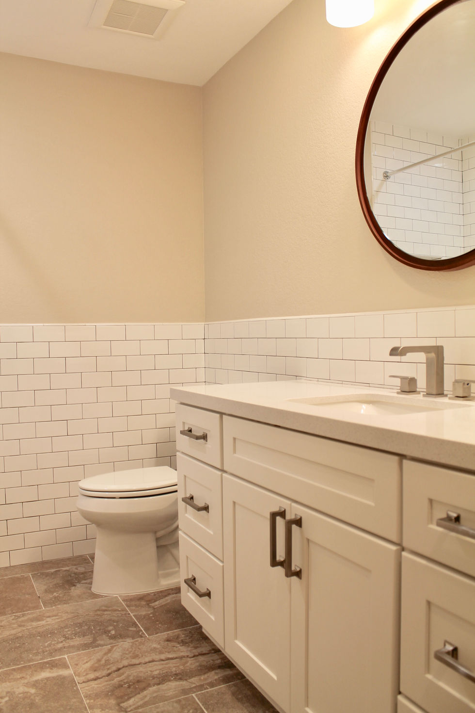 White Cabinets, Round wood Mirror, Quartz Countertops, White Subway Tile, Off White Paint