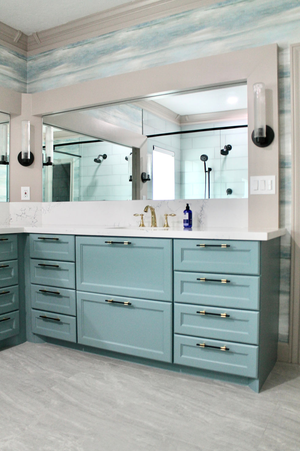 Blue Cabinets, Gold and Black Hardware, White Quartz Countertops, Large Format Floor Tile, Large Mirrors, Dual Shower, Bench, Wall Sconces