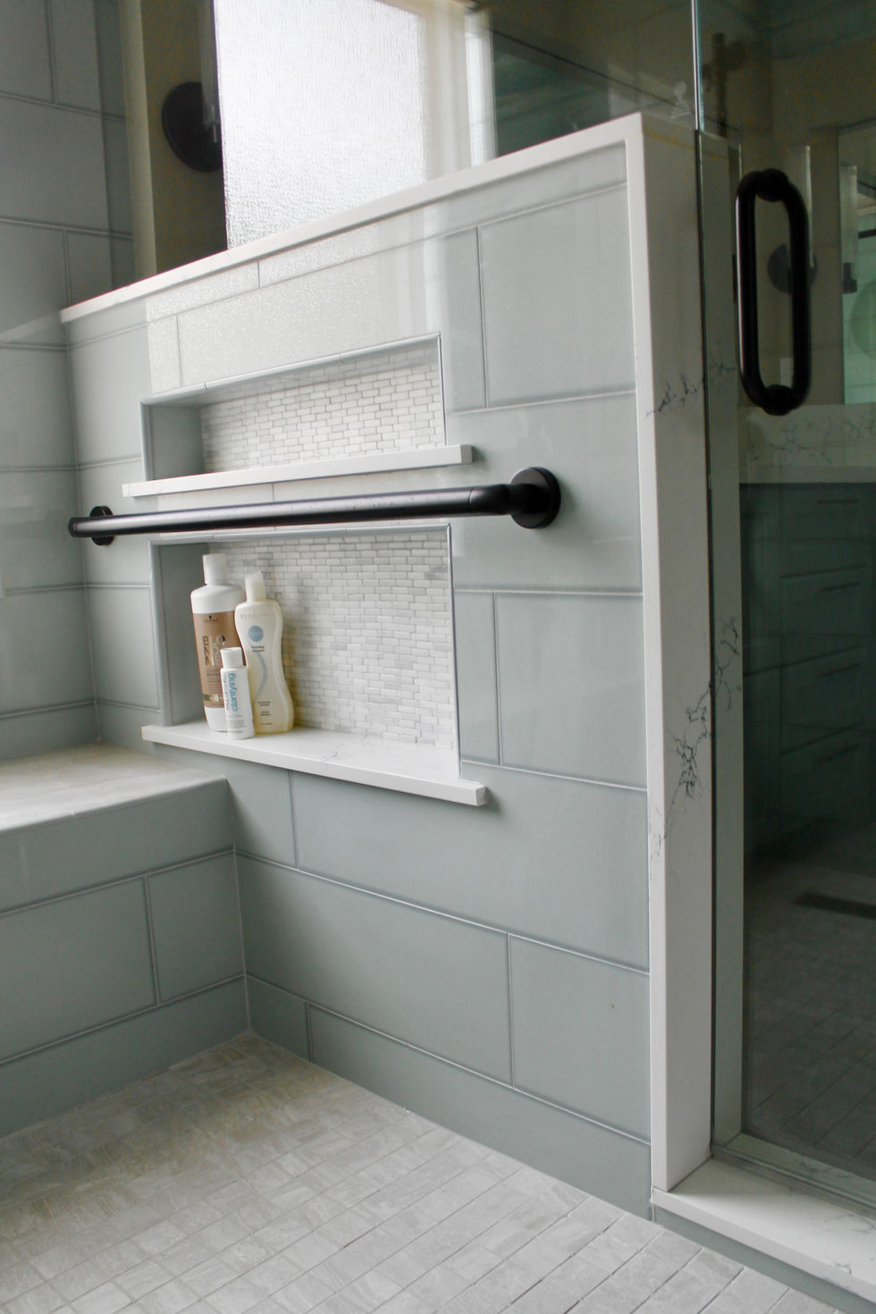 Blue Cabinets, Gold and Black Hardware, White Quartz Countertops, Large Format Floor Tile, Large Mirrors, Dual Shower, Bench, Shower Niche, Grab Bars
