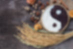 Yin Yang sign with black rice and jasmine white rice on wooden background. Concept health