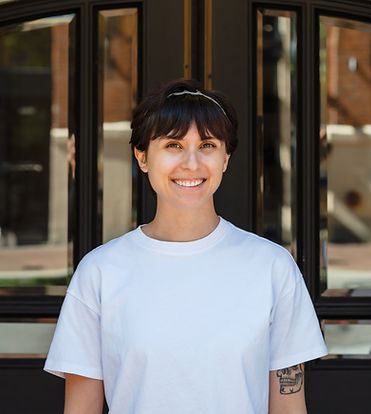 Short haired brunette woman smiling in a white tshirt who offers manual lymphatic drainage at BoDo Chiro in Boise