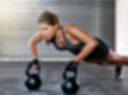 Athletic Woman With Kettlebells