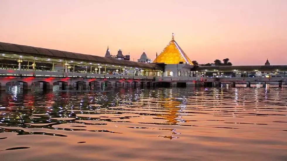 Eye-level view of the sacred pond reflecting the temple